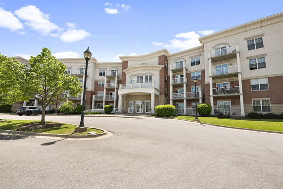 Front view of a multi-story residential building with balconies.
