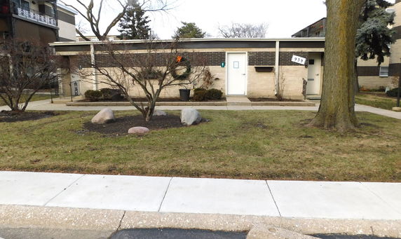 Front view of a building with brick facade and single entrance.