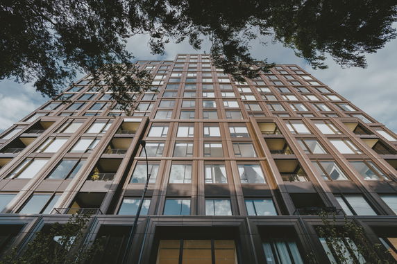 Front view of a modern multi-story building with large windows.