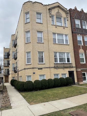 Front view of a multi-story brick apartment building.