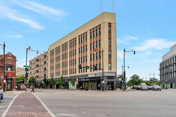 Front view of a multi-story commercial building with large windows.