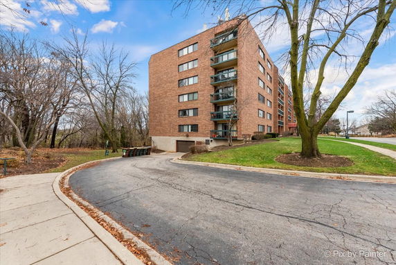 Front view of a multi-story brick apartment building.