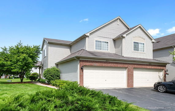 Front view of a two-story house with a double garage.