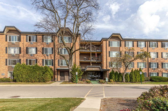 Front view of a multi-story brick apartment building.