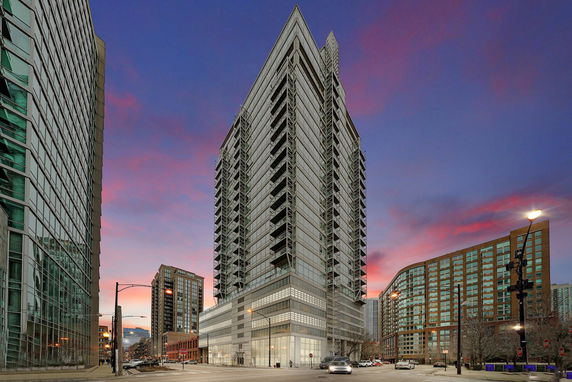 Front view of a modern high-rise building with large glass windows.