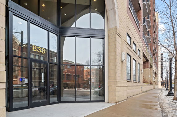 Front view of a multi-story building with large glass entrance.