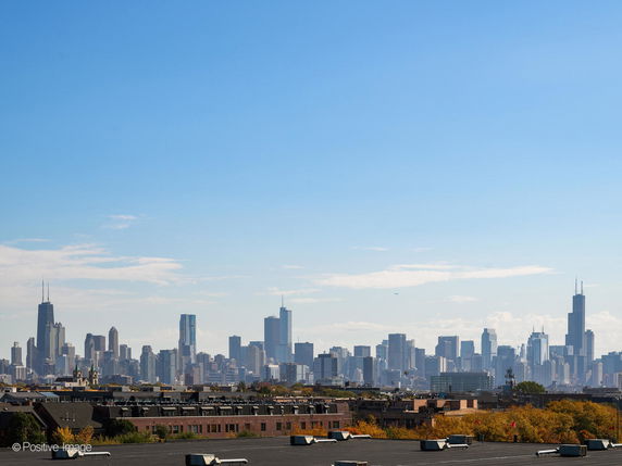Panoramic view of a city skyline from a rooftop.