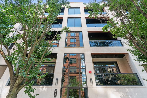 Front view of a multi-story building with modern design and large windows.