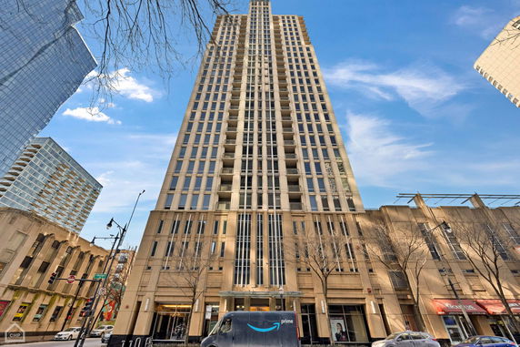 Front view of a tall building with multiple floors and a symmetrical facade