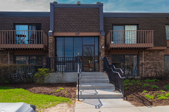 Front view of a two-story brick building with balconies.