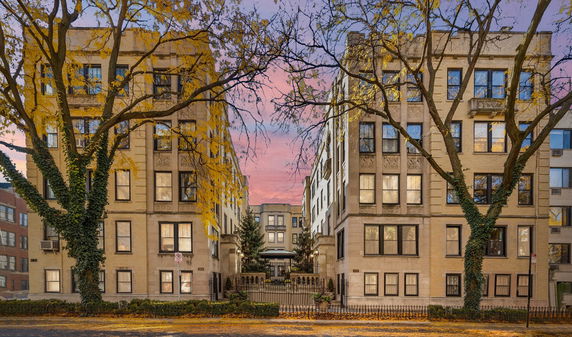 Front view of a multi-story residential building with ornate facade details.