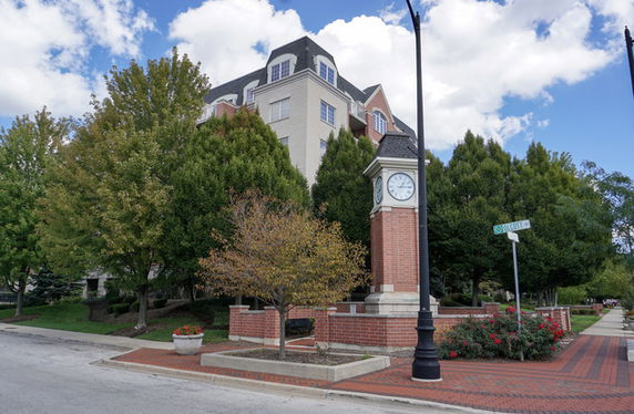 Front view of a multi-story building with a clock tower.