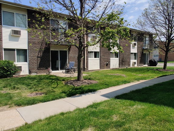 Front view of a two-story brick apartment building.