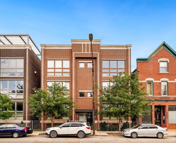 Front view of a three-story brick apartment building.