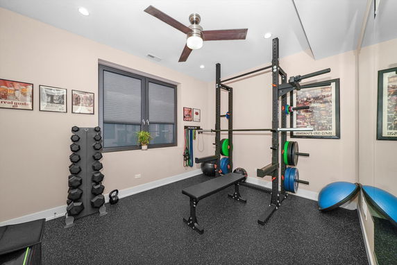 Home gym area with weights, bench, and fitness equipment.