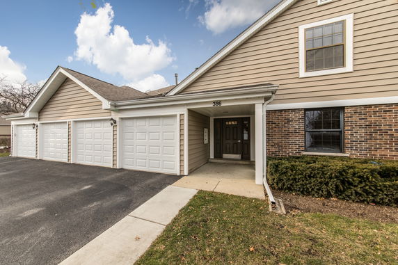 Front view of a house with a triple garage and an entrance on the right.