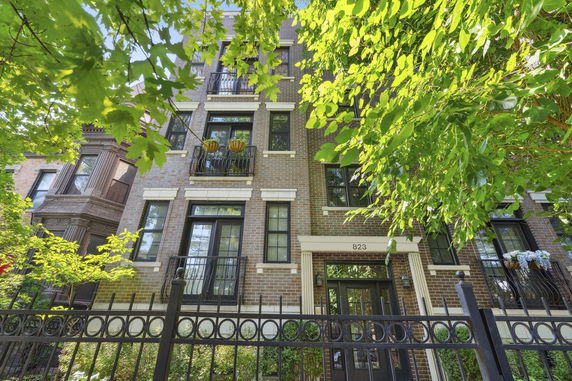 Front view of a multi-story brick building with balconies.