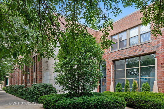 Front view of a brick building with large windows