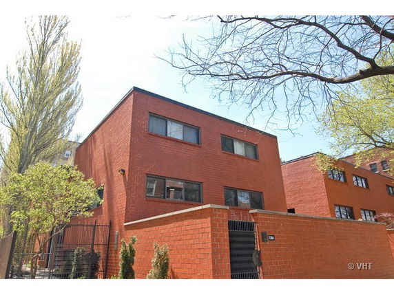 Front view of a modern two-story brick building with a flat roof.