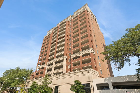 Front view of a multi-story brick building with balconies.