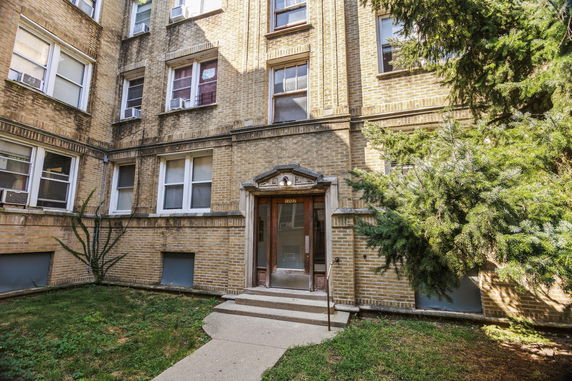 Front view of a multi-story brick building entrance.