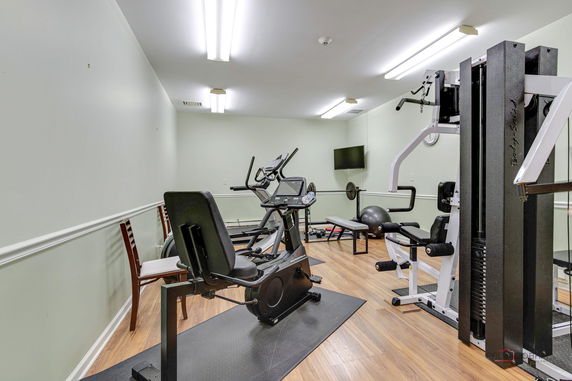 Room with gym equipment and wooden flooring