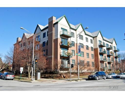 Front view of a four-story apartment building with balconies.