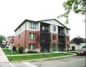 Front view of a three-story brick apartment building.