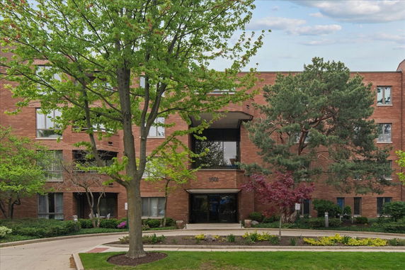 Front view of a multi-story brick building with entrance.