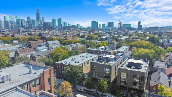 Panoramic cityscape with a view of buildings and a dense urban area.