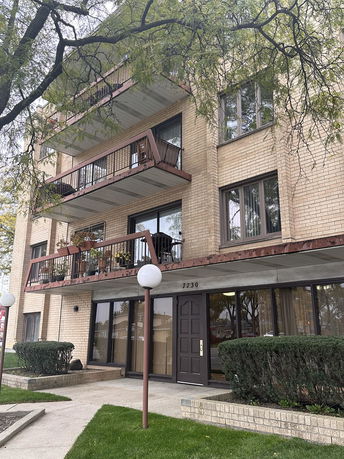 Front view of a multi-story residential building with balconies.