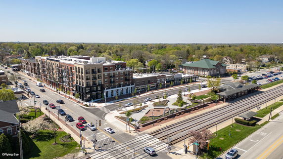 Panoramic view of a residential and commercial area with a train station.