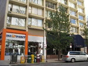 Front view of a multi-story building with retail space on the ground floor.