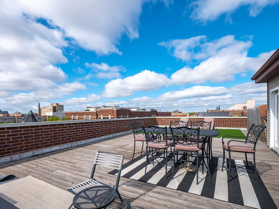 Rooftop area with seating and city skyline views.