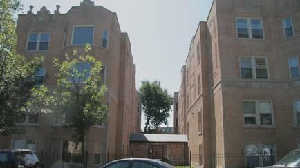 Front view of a multi-story brick apartment building.