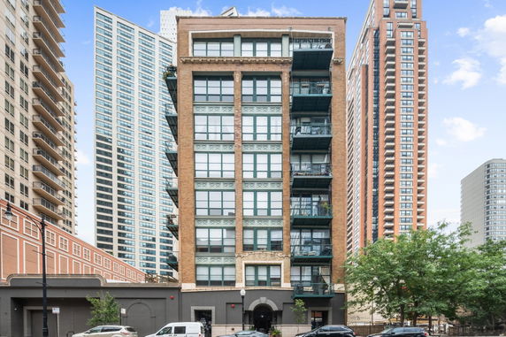 Front view of a multi-story apartment building with balconies.