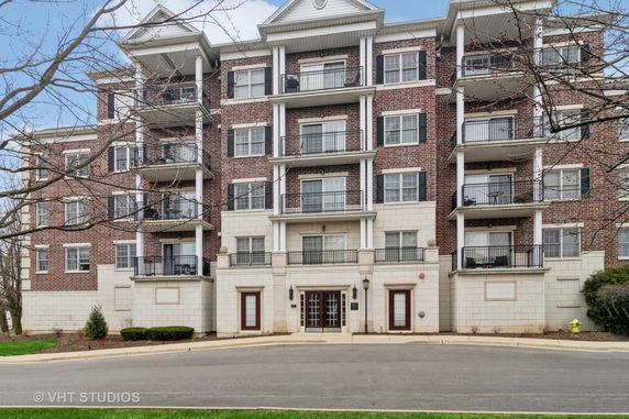 Front view of a multi-story residential building with balconies.