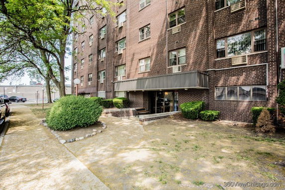 Front view of a multi-story brick apartment building.