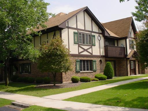 Front view of a two-story house with Tudor-style architecture.