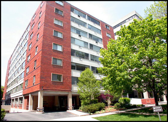 Front view of a multi-story brick apartment building.