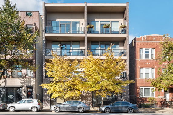 Front view of a multi-story residential building with balconies.