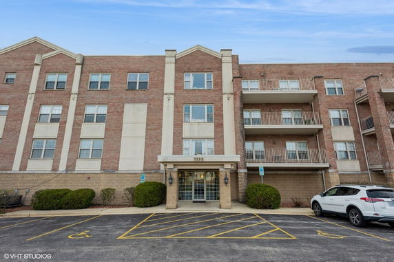 Front view of a multi-story brick building with balconies.