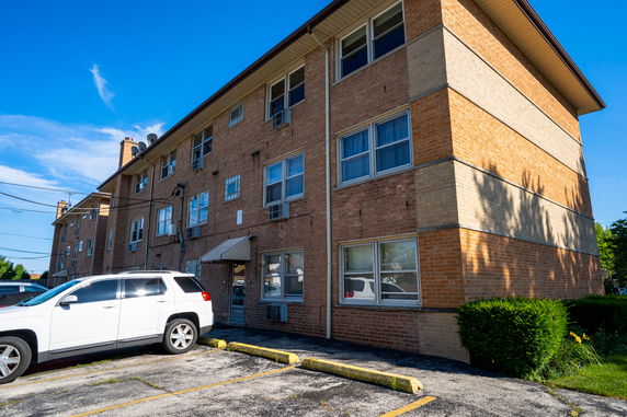 Front view of a multi-story brick apartment building.