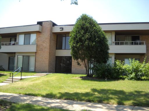Front view of a two-story apartment building with balconies.
