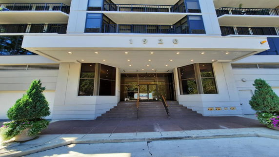 Front view of a multi-story building with a canopy entrance.