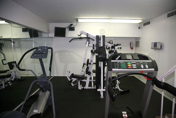 Indoor gym area with exercise equipment.