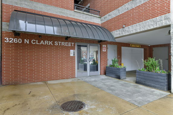 Front view of a building entrance with a covered walkway.