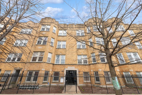 Front view of a multi-story brick apartment building.