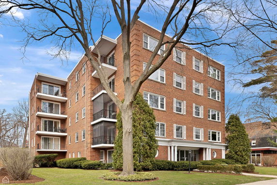 Front view of a multi-story brick building with balconies.