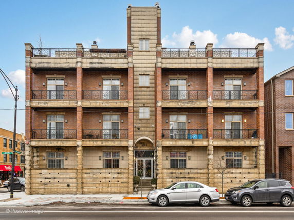 Front view of a multi-story brick apartment building.